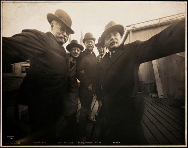 Historial photograph of men taking self photo ie selfie