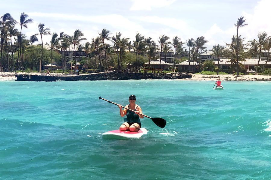 Cookies & Clogs | Oceans Sports Aloha Days offer 4 hours of unlimited water sports beach equipment including kayaks, stand-up paddleboards, snorkel gear, and rides on the glass bottom boat. One of the many things to do on the Big Island of Hawaii with kids. Standup paddleboarding SUP