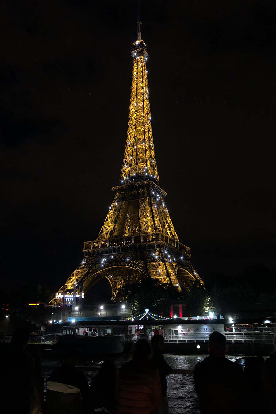 Best Paris boat tour tips for sightseeing cruise on the Seine River in Paris, France. Eiffel tower at night sparkling