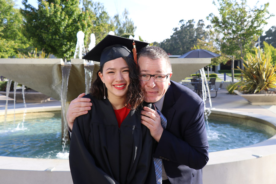 My daughter's high school graduation with photos of the ceremony — Class of 2019 plus her journey from homeschool to high college program; female student with her father