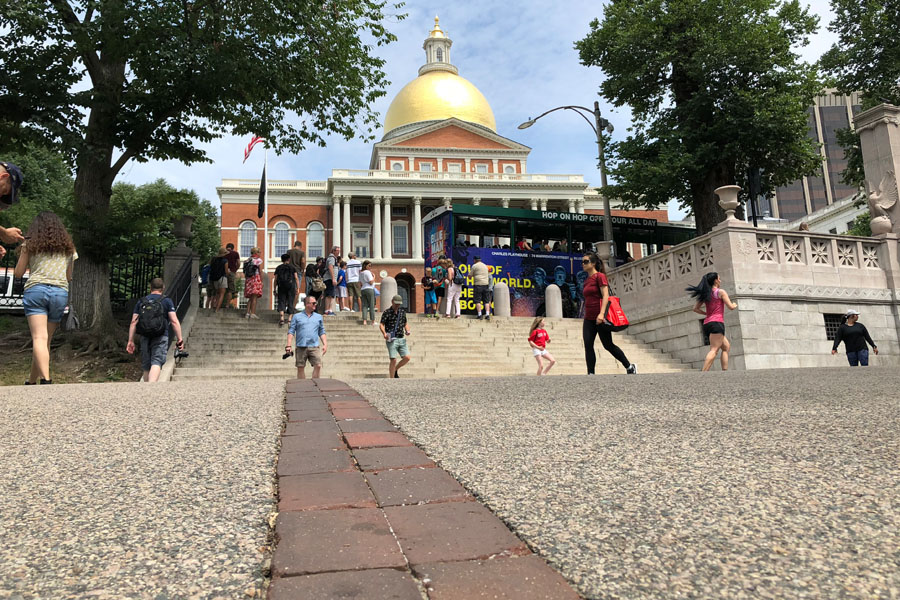 Family travel tips for visiting the Boston Freedom Trail in Boston, Massachusetts with historic sites - Brick path and State House