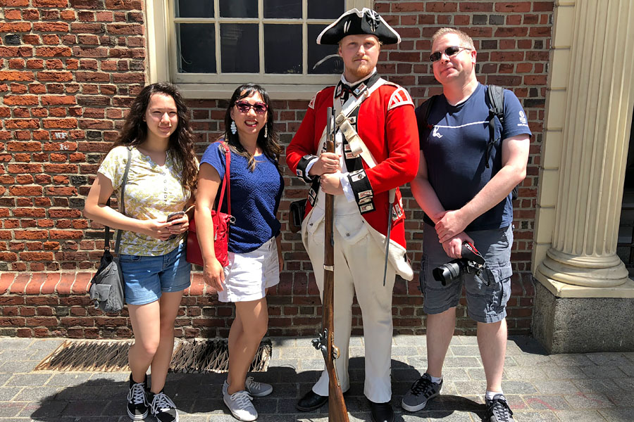 Family travel tips for visiting the Boston Freedom Trail in Boston, Massachusetts with historic sites - family with costume Red Coat Soldier