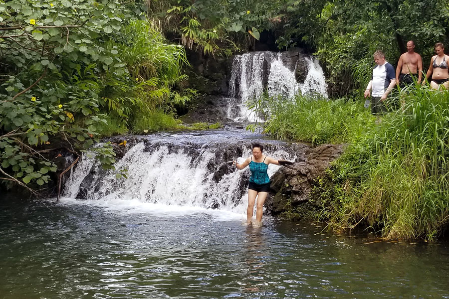 Kauai ATV Waterfall tour with family / teens in Ohana Bug in Kauai Hawaii Jumping in Waterfall