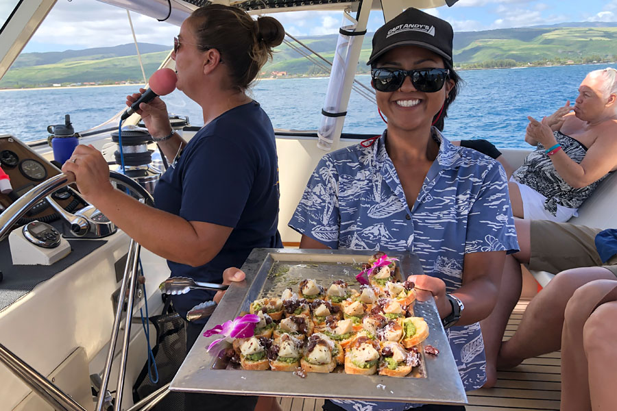 Top things to do in Kauai Hawaii — Kauai Napali Coast boat tour / Na Pali Coast sunset cruise captain crew and appetizer