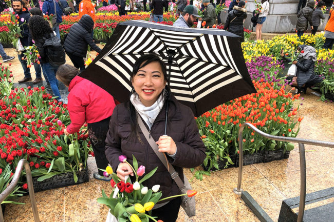 2020 Flower Bulb Day in San Francisco on March 7th! at Union Square in San Francisco on March 7. Photo from 2019 free tulips event chinese woman with umbrella and tulips.