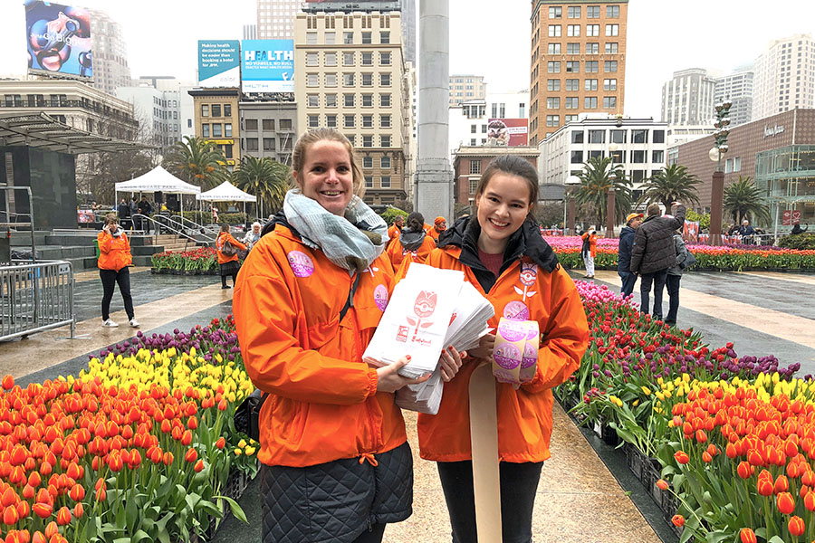 2020 Flower Bulb Day in San Francisco on March 7th! at Union Square in San Francisco on March 7. Photo from 2019 free tulips event Staff in orange with paper bags